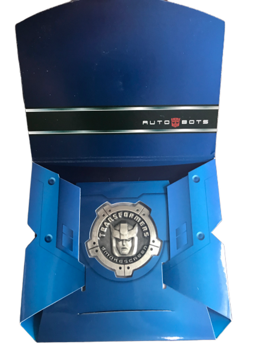 [EN STOCK] Accesorio Moneda Metálica Conmemorativa - Transformers MP-19 Smokescreen marca Hasbro / Takara